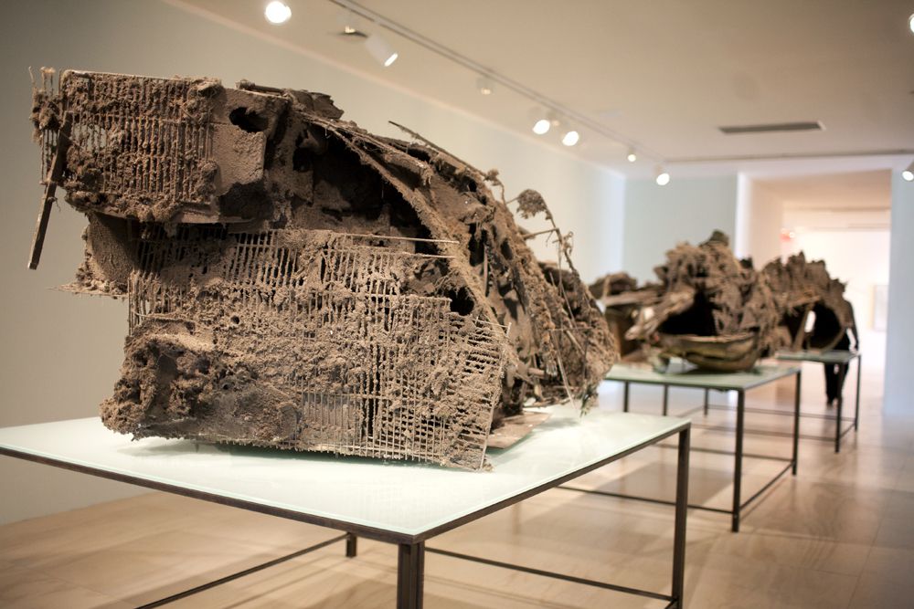 Peter Buggenhout's "The Blind Leading the Blind" consists of polystyrene, polyester, iron, wood, trash, and other material covered with household dust.<br/>